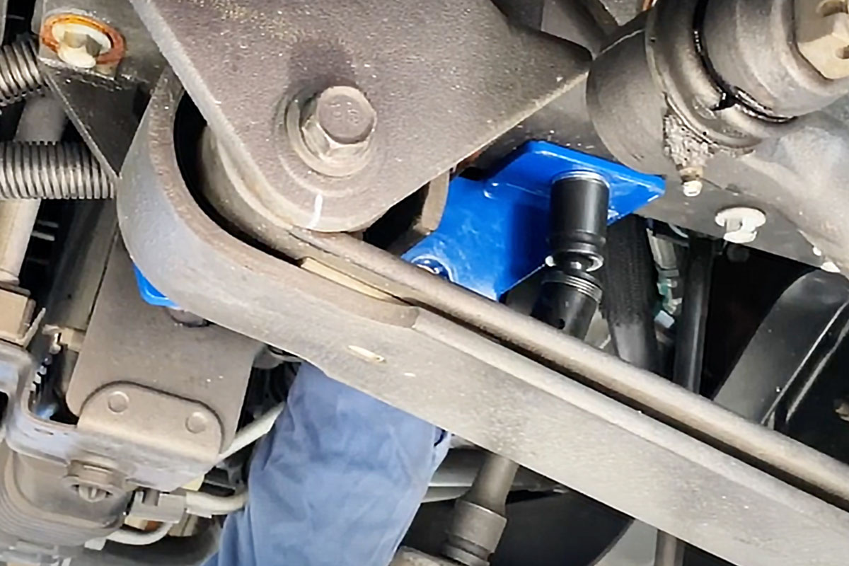 The installation begins with removal of the (15/16”) nut from the front spring eye bolt on each side. The nuts are re-used. The SS403-2 frame bracket is placed with the flat crossplate towards the rear facing up, over the spring eye bolt. One of the supplied ½”x1.5” frame bolts, along with a nut and flat washer, is used to loosely bolt the crossplate to the frame. Then the nut on the front spring eye bolt is replaced (use thread locker on both the new bolt and the spring eye bolt nut.)