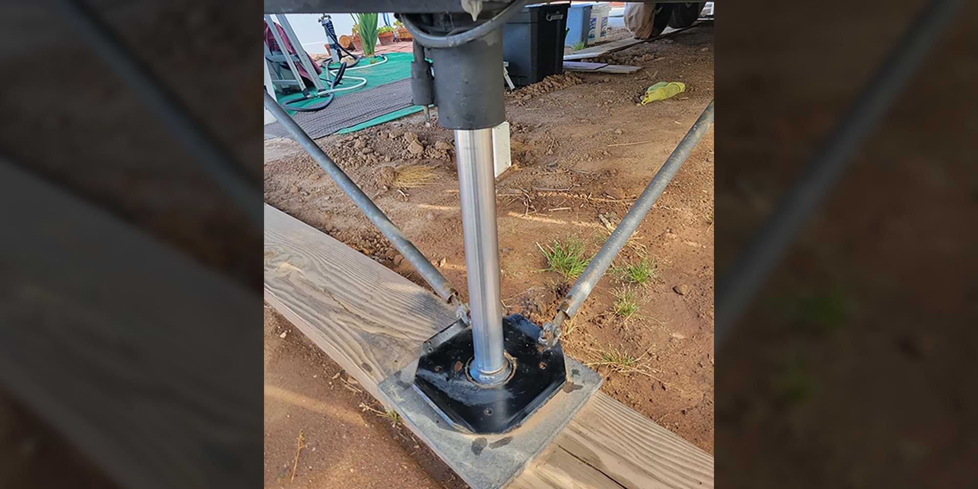 close view of a leveling jack under an RV