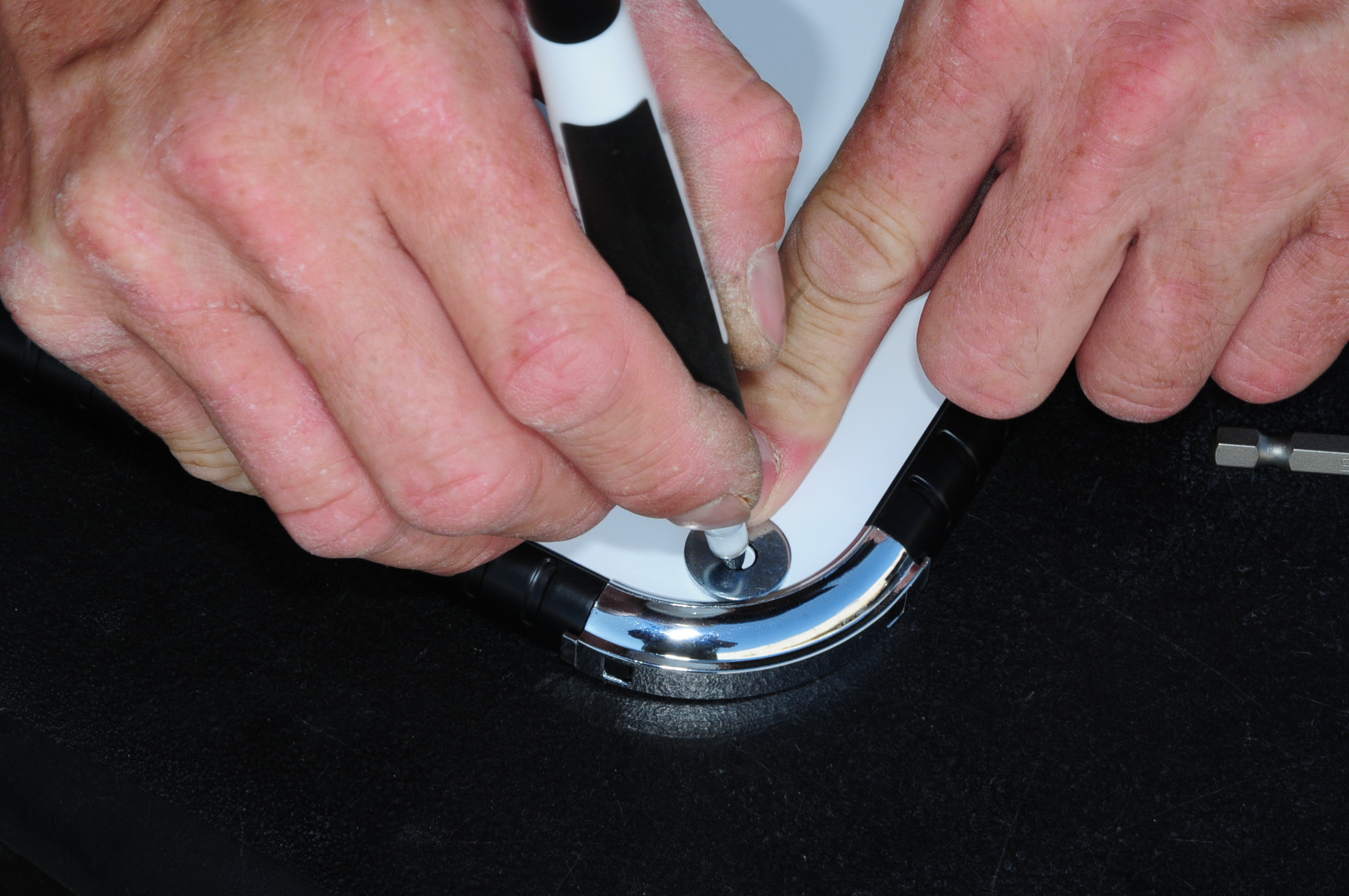 technician marks a washers placement on a white board corner using the provided white board marker