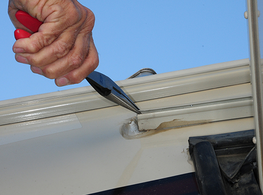 opening end of awning rail with pliers