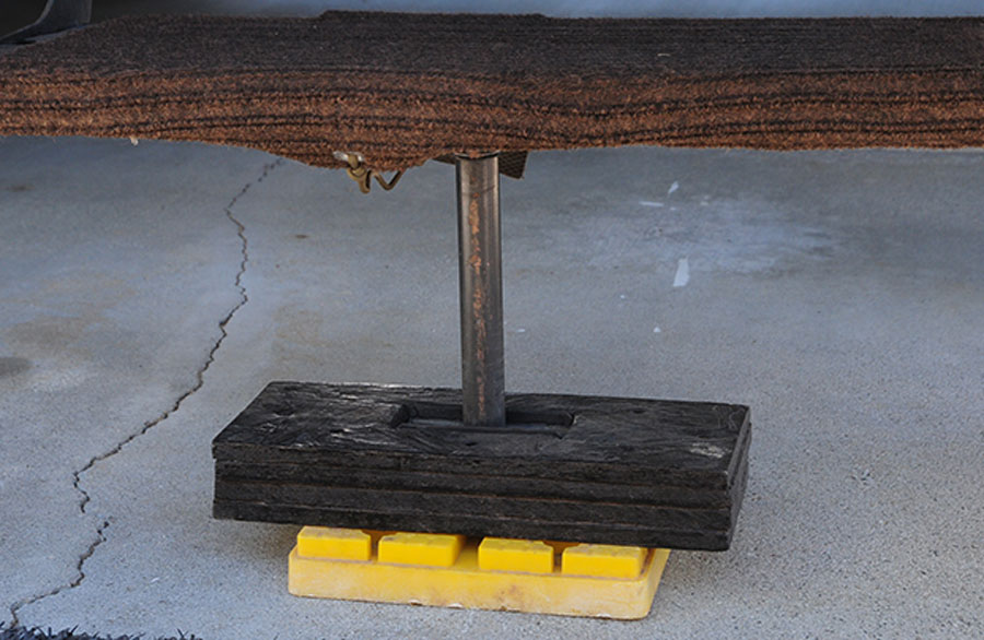 An RV step support with a common configuration of a pad for the ground and a threaded rod is attached to the bottom rung to provide better stability. The bottom rung takes most of the beating due to leverage applied when entering and exiting the RV. Another option is to use a carpet cover on the bottom step, which will help remove debris from shoes while still offering traction for a solid foothold