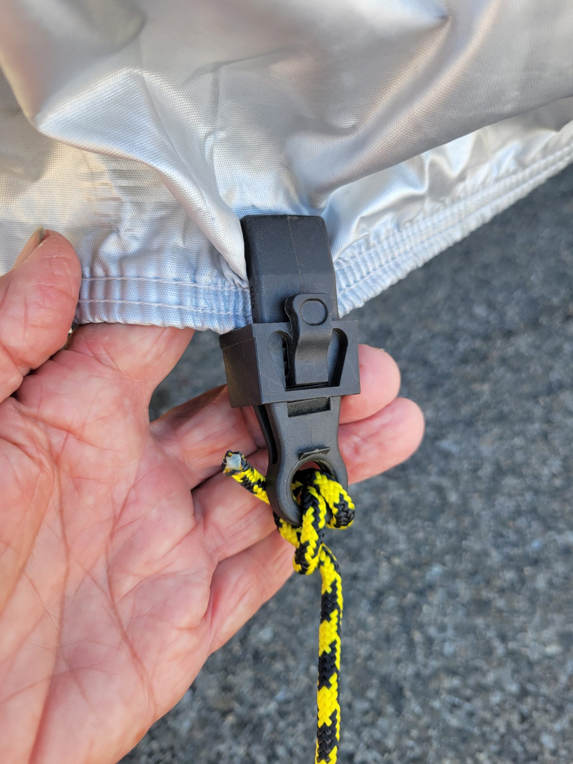 close view of a plastic clamp attached to the car cover
