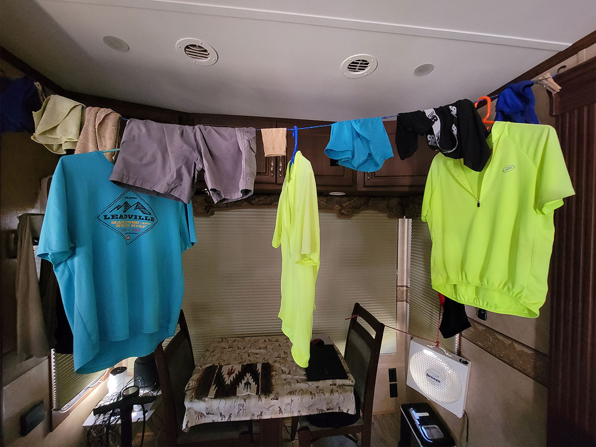 a rope holding clothes on hangers runs across an RV space 