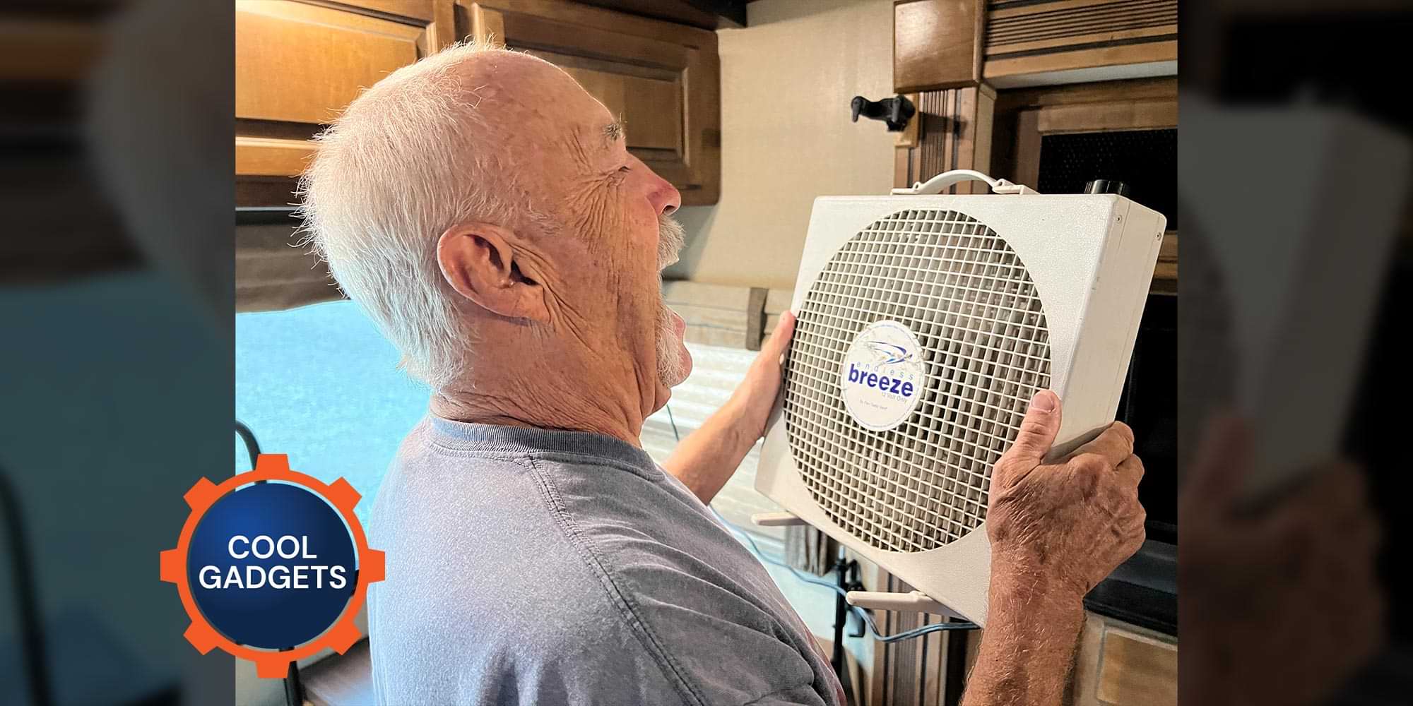 technician holds an Endless Breeze fan in an RV