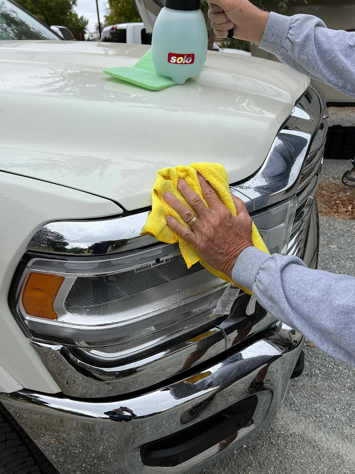with the vehicles bugs cleared, a microfiber towel is used to dry the newly polished area