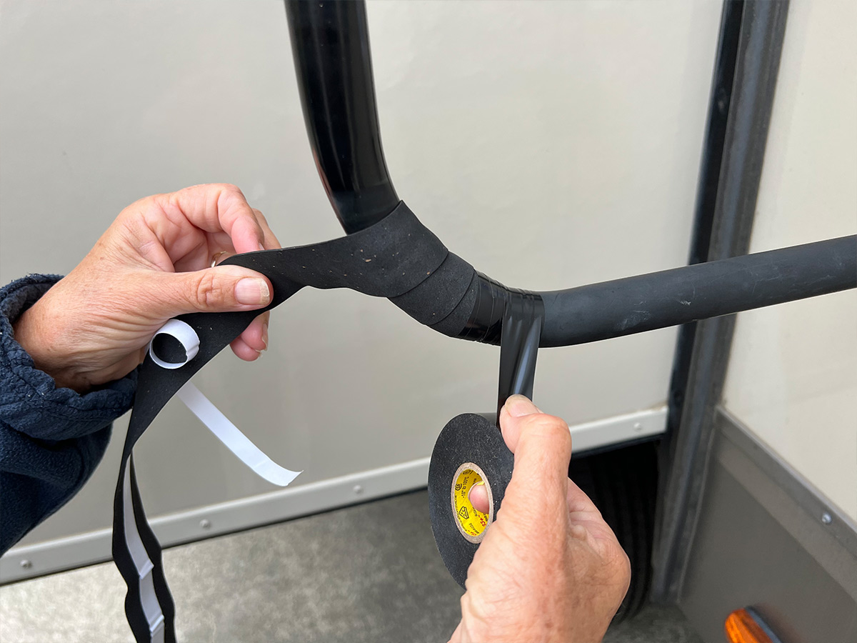 the handlebar tape is applied to the handlebar, the end sealed with multiple wraps of black electrical tape