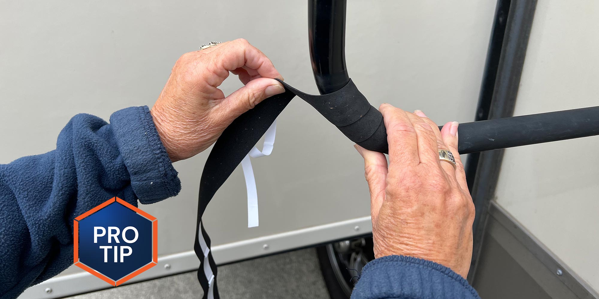 close view of hands wrapping grip material around a handle on an RV