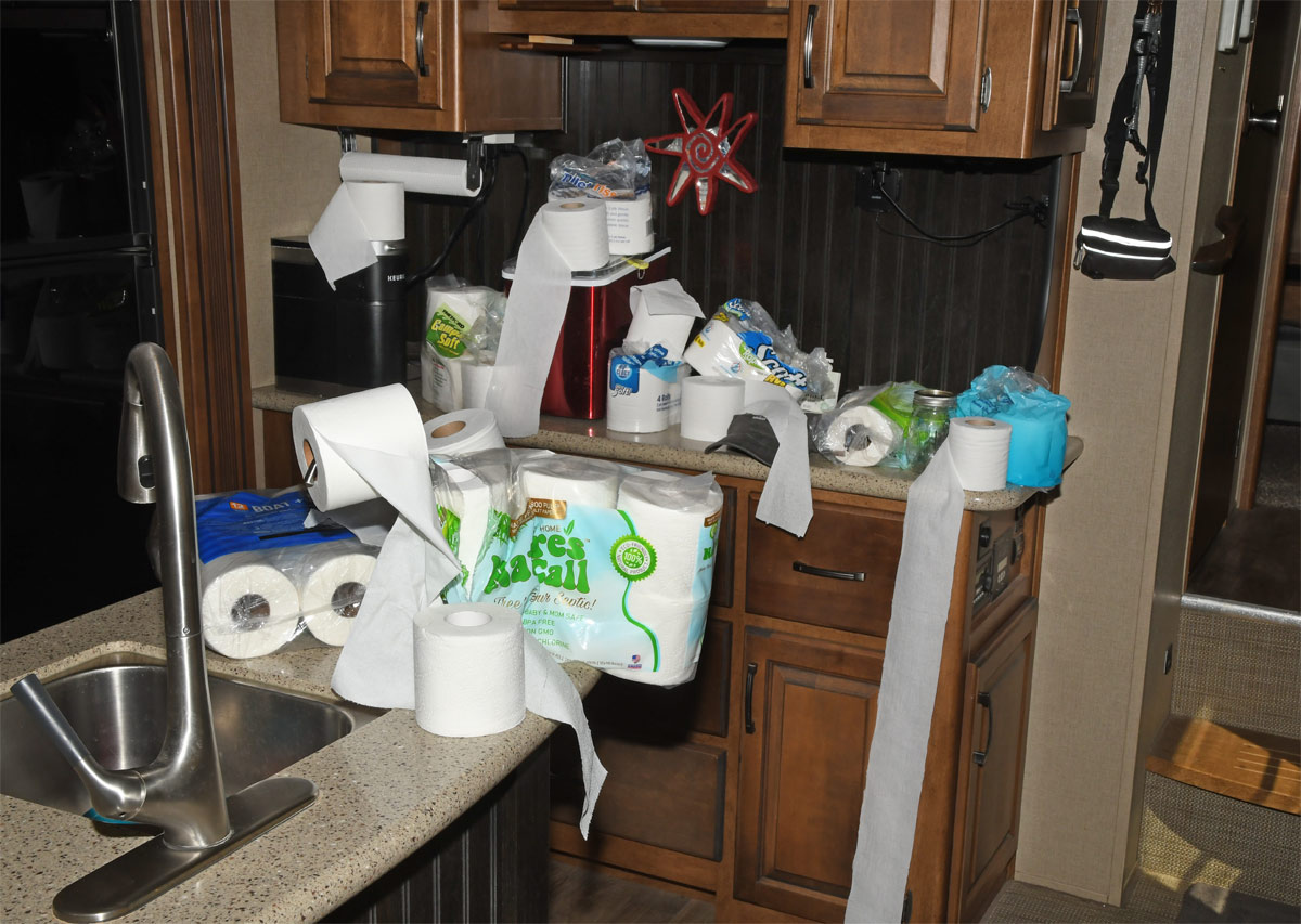 kitchen counters topped with various brands of toilet paper