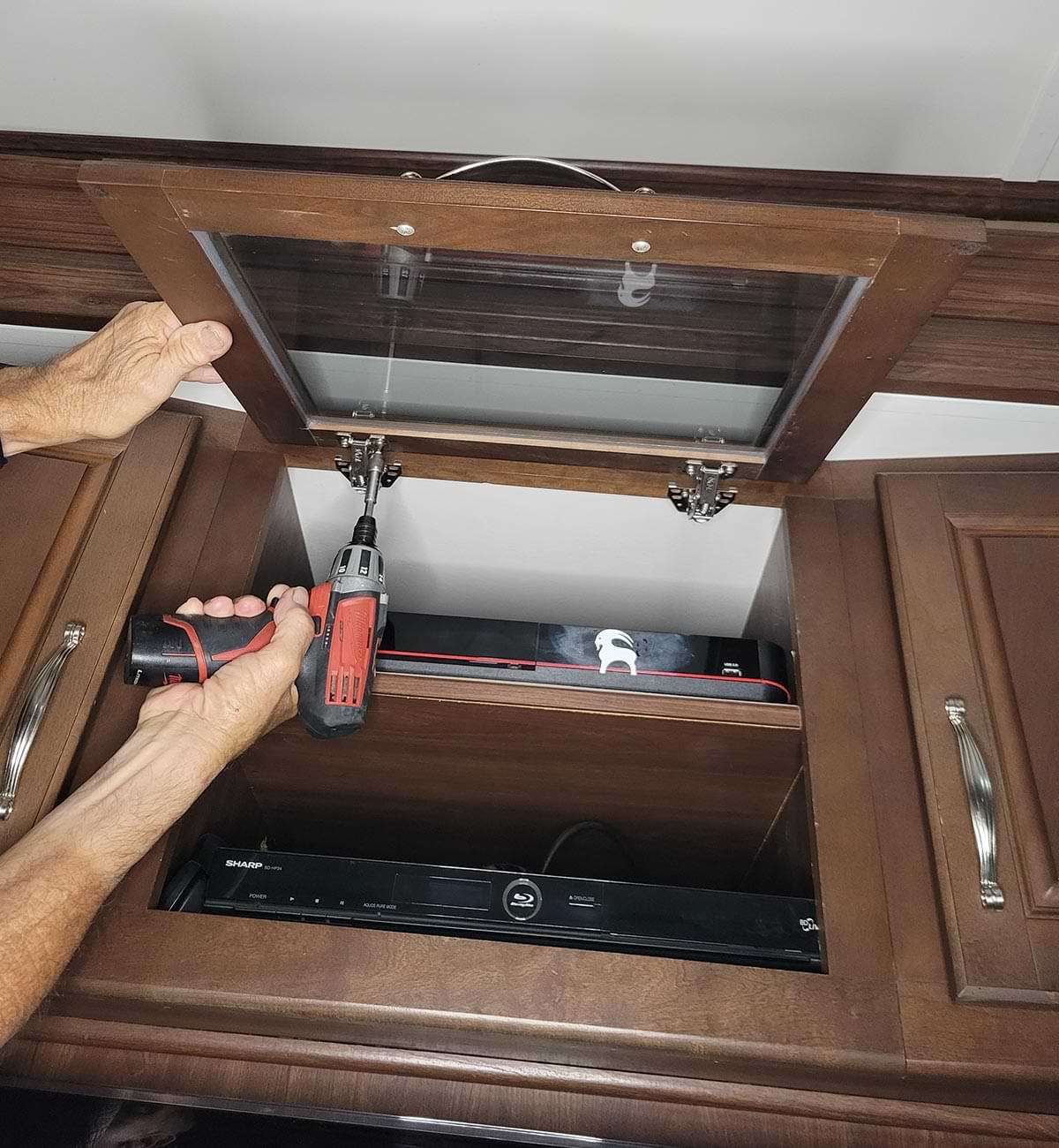 a screw gun is used to remove the door from the hinges