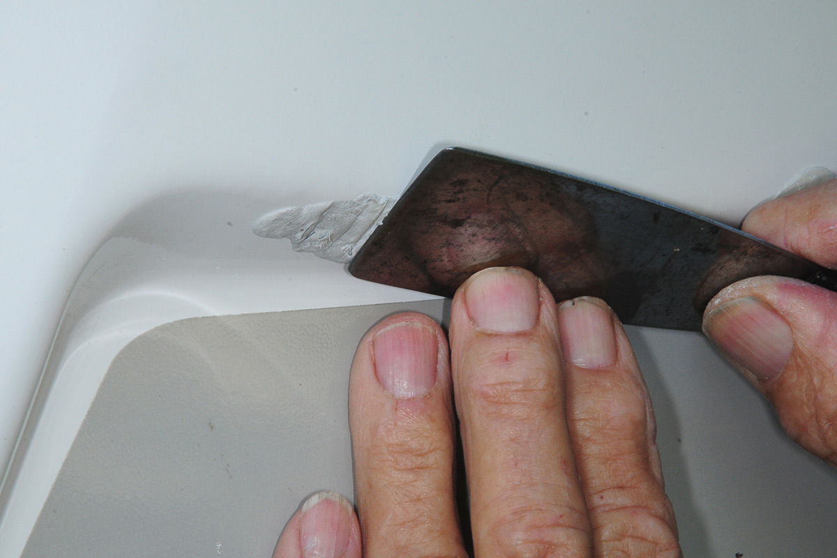 the putty knife is used to smooth out the WaterWeld