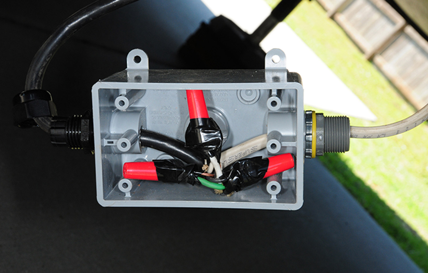 the junction box with wires organized and secured with electrical tape