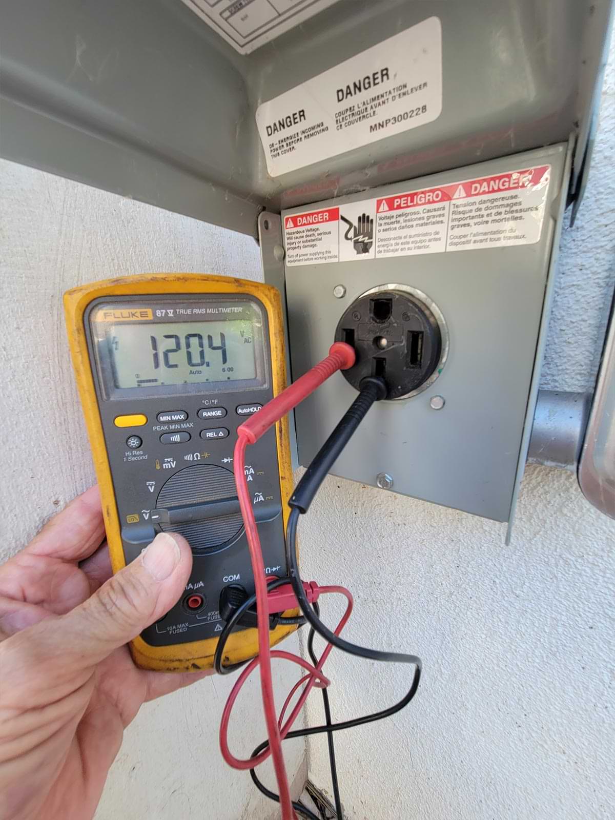 a receptacle is configured in a 50-amp hookup box using probes and a multimeter