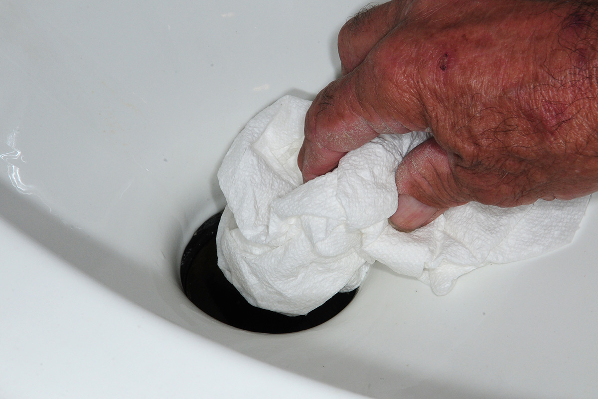 paper towels are stuffed down the hole before removing the old seal