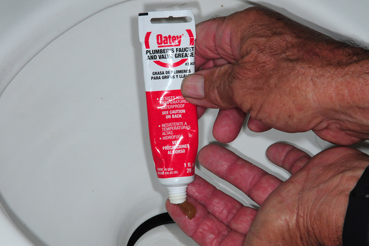 Oatey Plumber's Faucet and Valve Grease is applied to the index finger