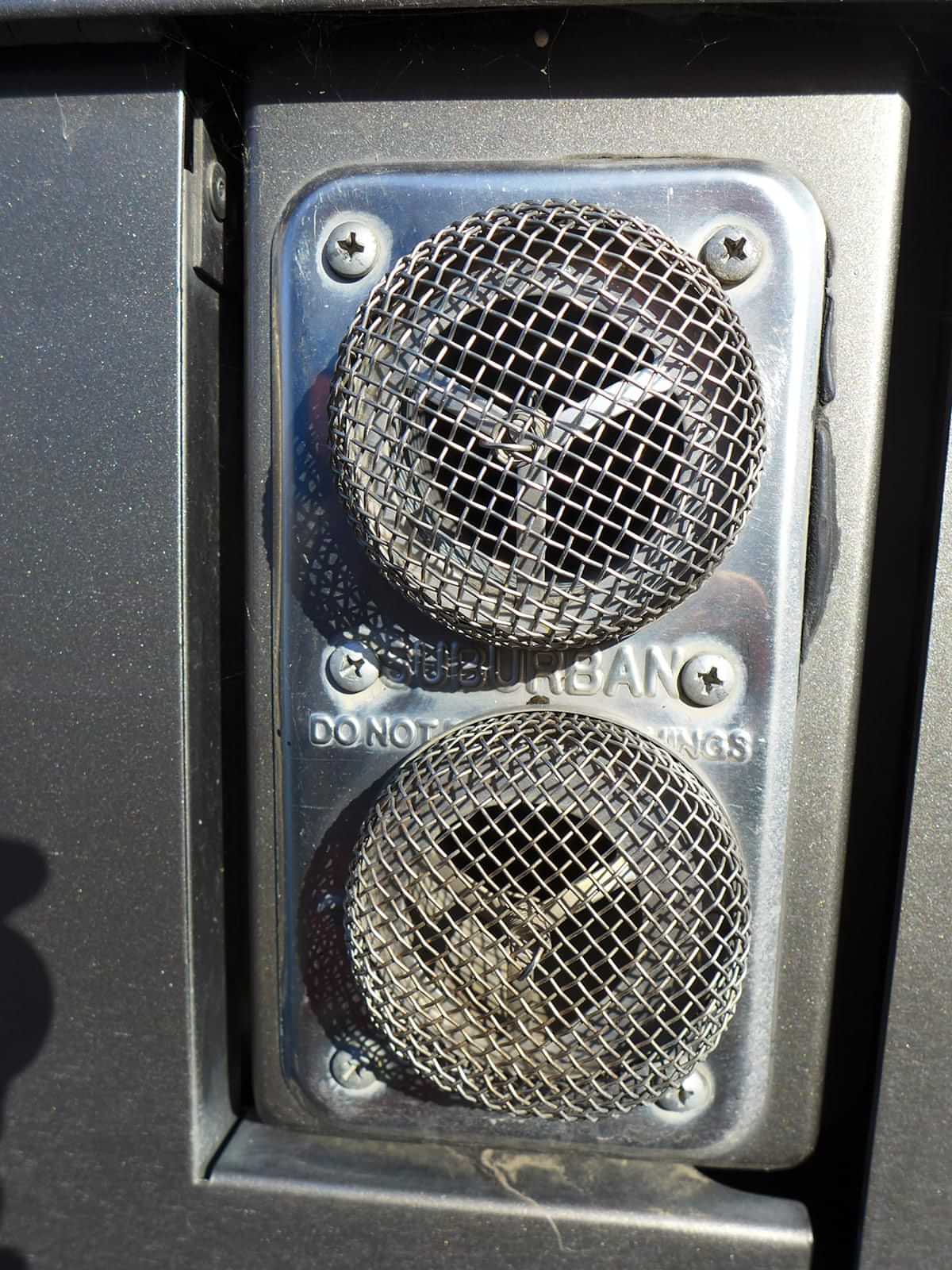 close view of the intake and exhaust ports covered with screens