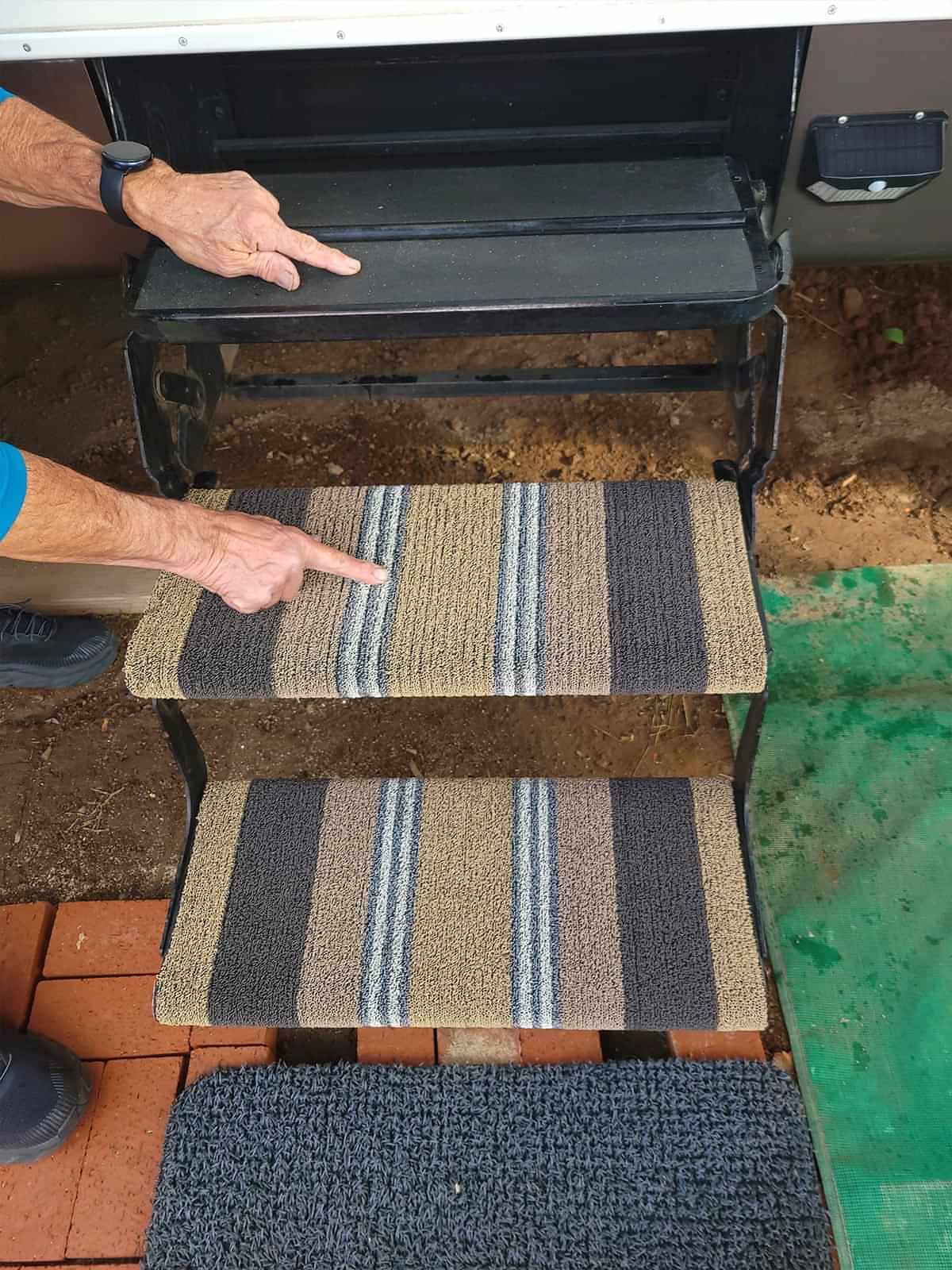 an RV's entry way steps with new ShadePro RV Step covers, save for the first step