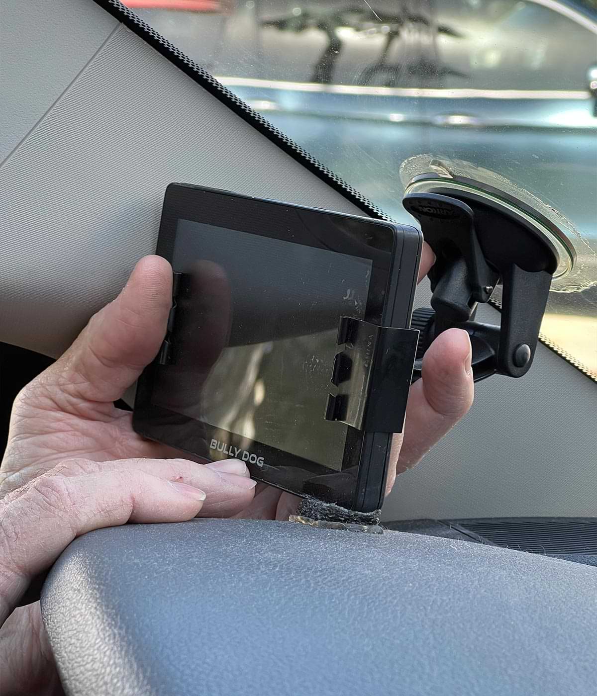 the monitor is adjusted while the suction-cup is attached to the windshield