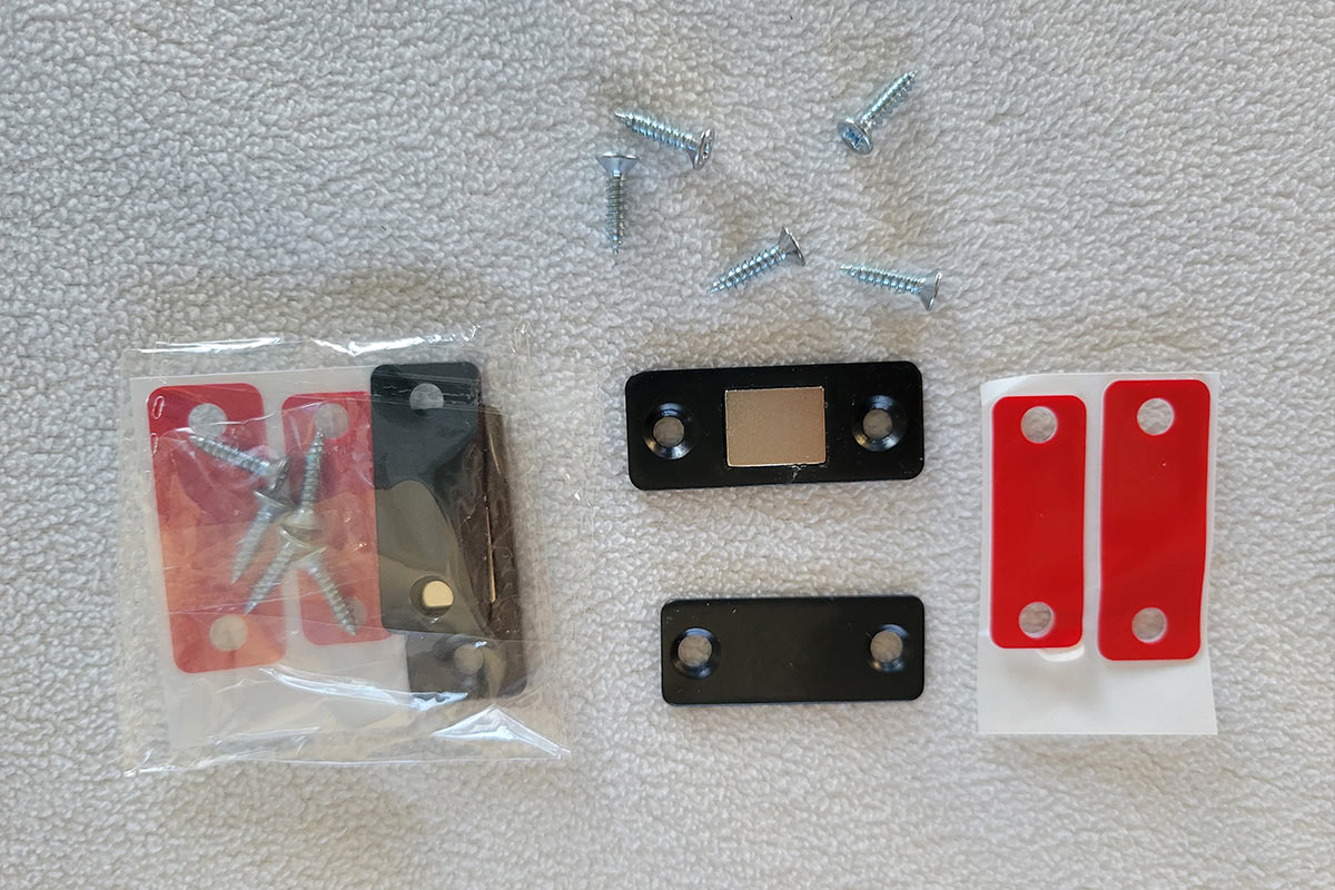 parts from a Magnetic cabinet catch kit laid out on a surface