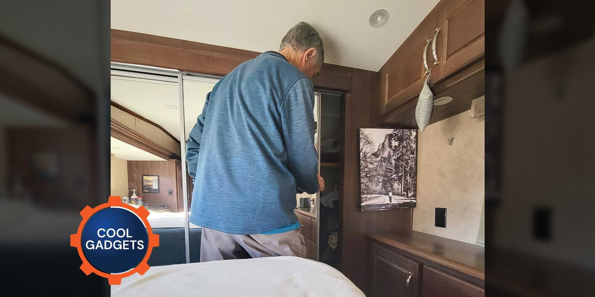 a man closes a closet door in an RV bedroom