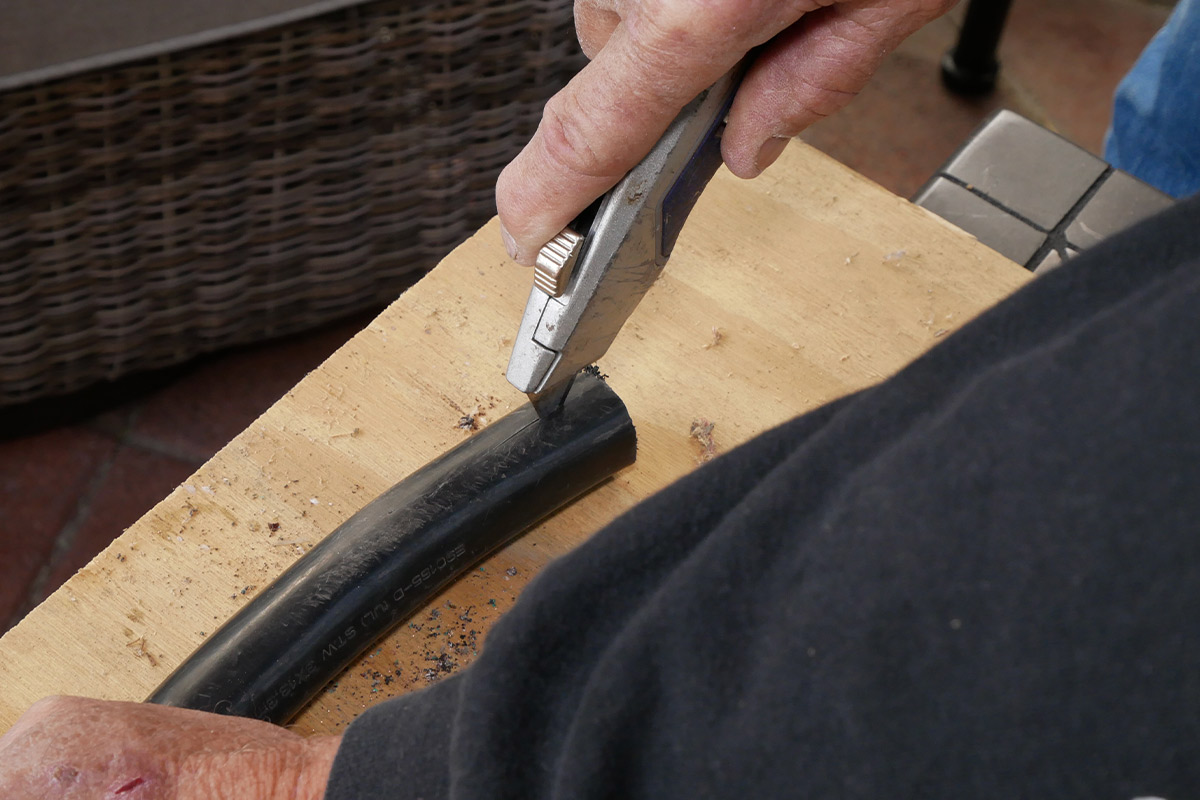 a utility knife is used to make a cut along the cord casing