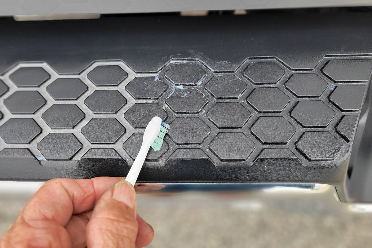 a toothbrush is used to penetrate the grooves in the pattern on the bumper