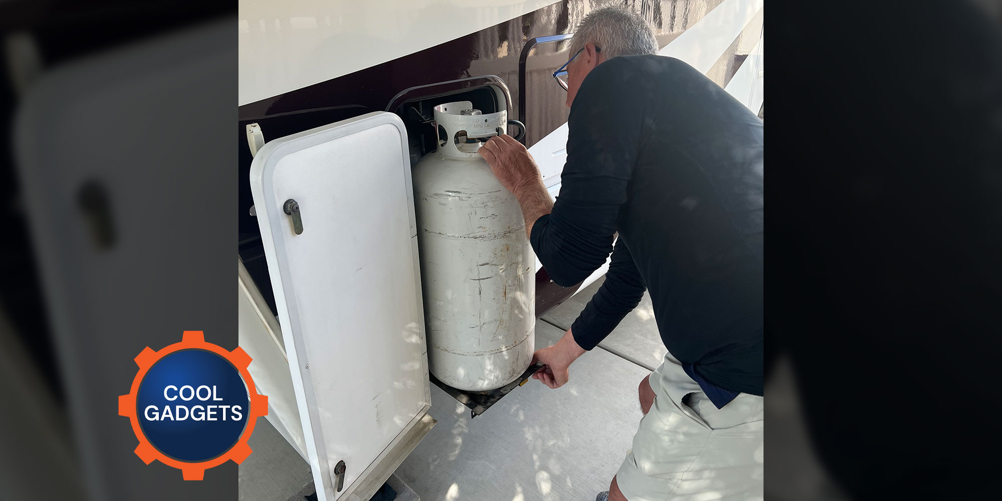 a man removes an LP-gas cylinder from an RV external compartment