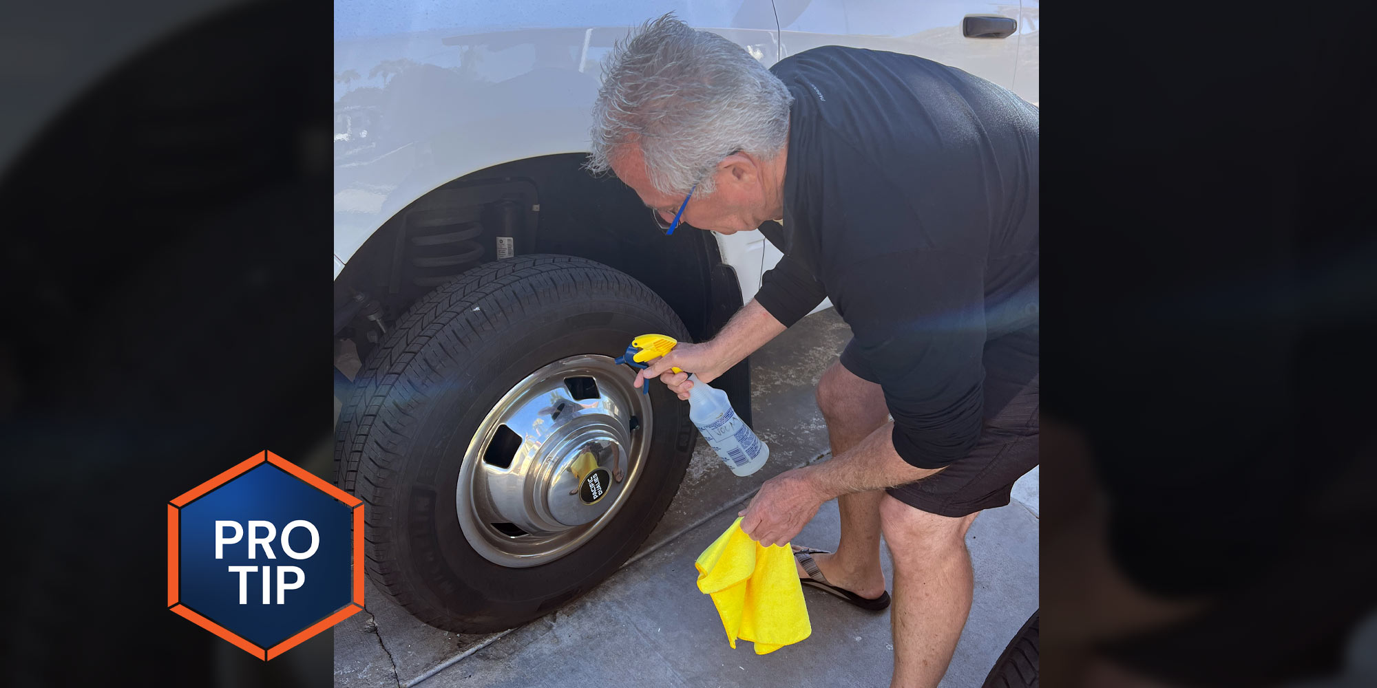 a man uses a spray bottle labeled VOOM on a tire rim