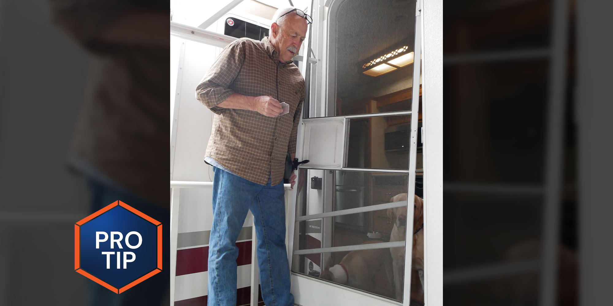 a man holds a screen door hinge part while standing outside an RV screen door hanging one hinge