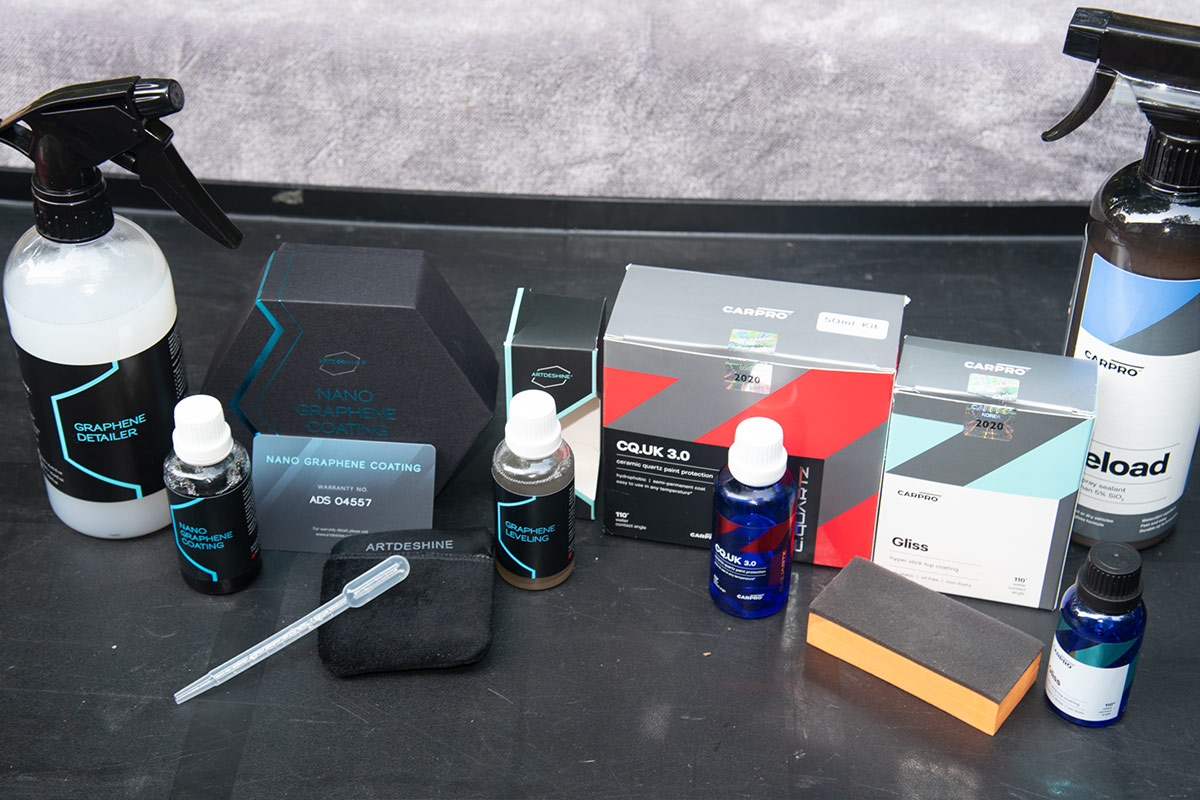 parts from the Artdeshine Nano Graphene and CarPro ceramic coating systems sit on a counter