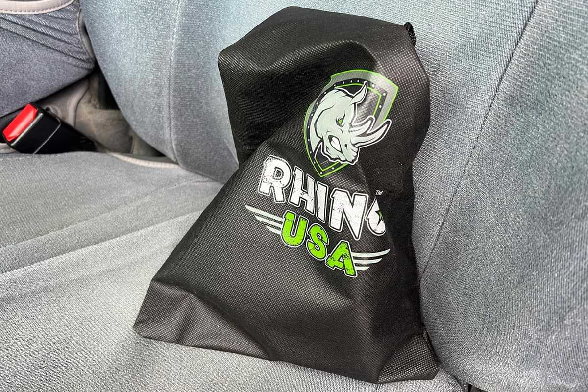 the Rhino USA storage bag meant to hold both straps sits placed on a truck seat