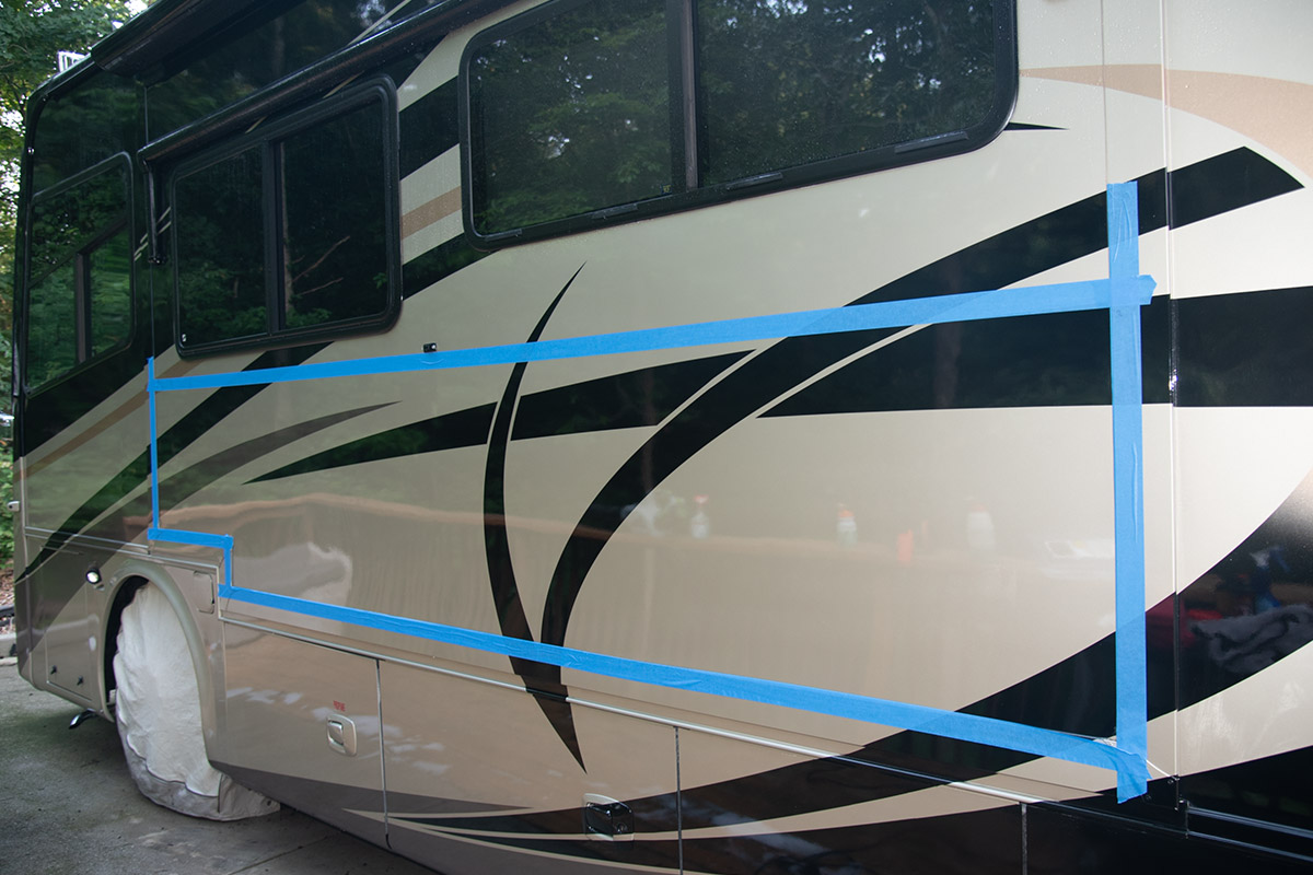 the long side of an RV with the central area sectioned off by blue painter's tape