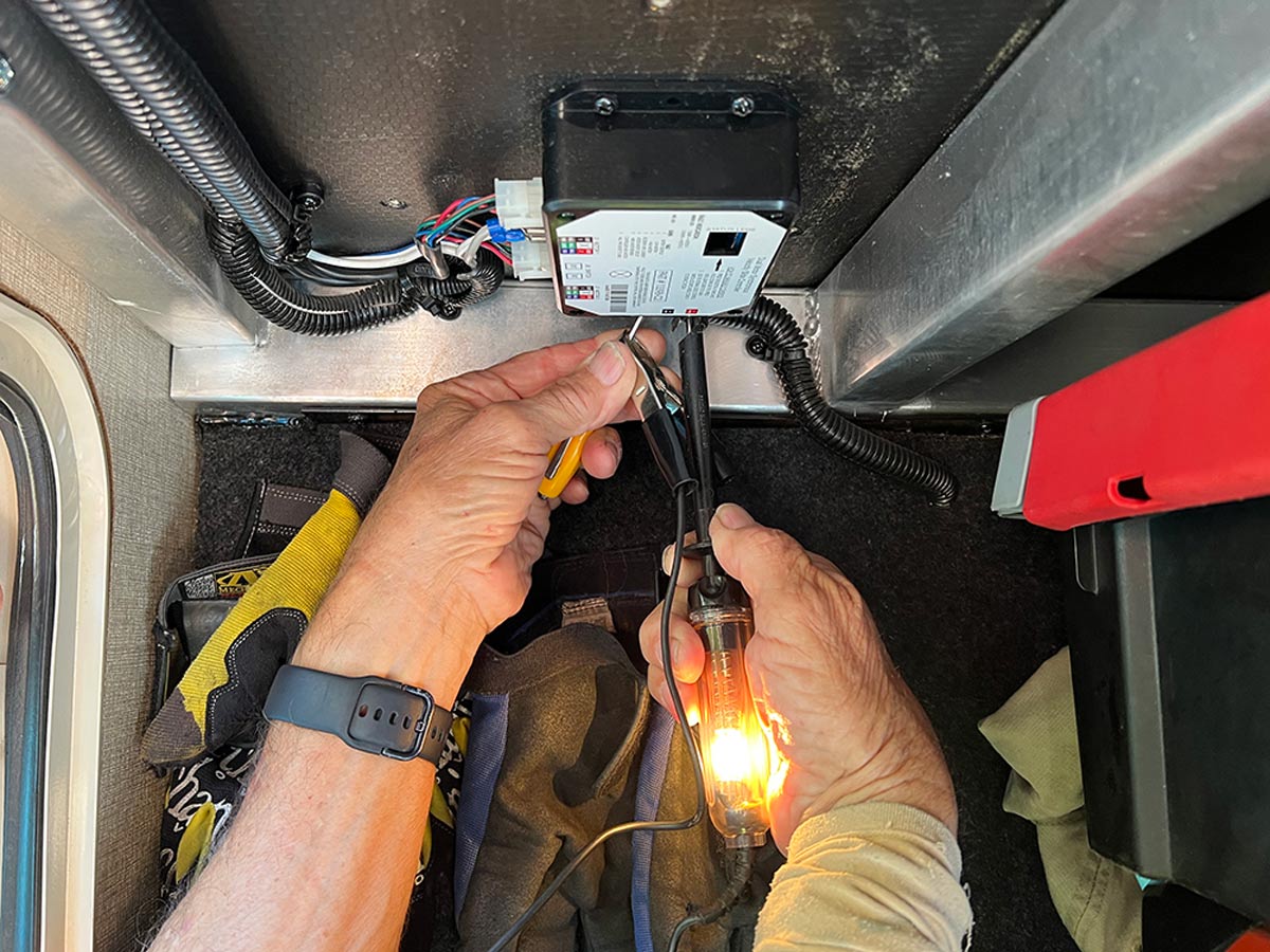 test light being used to check 12-volt dc power