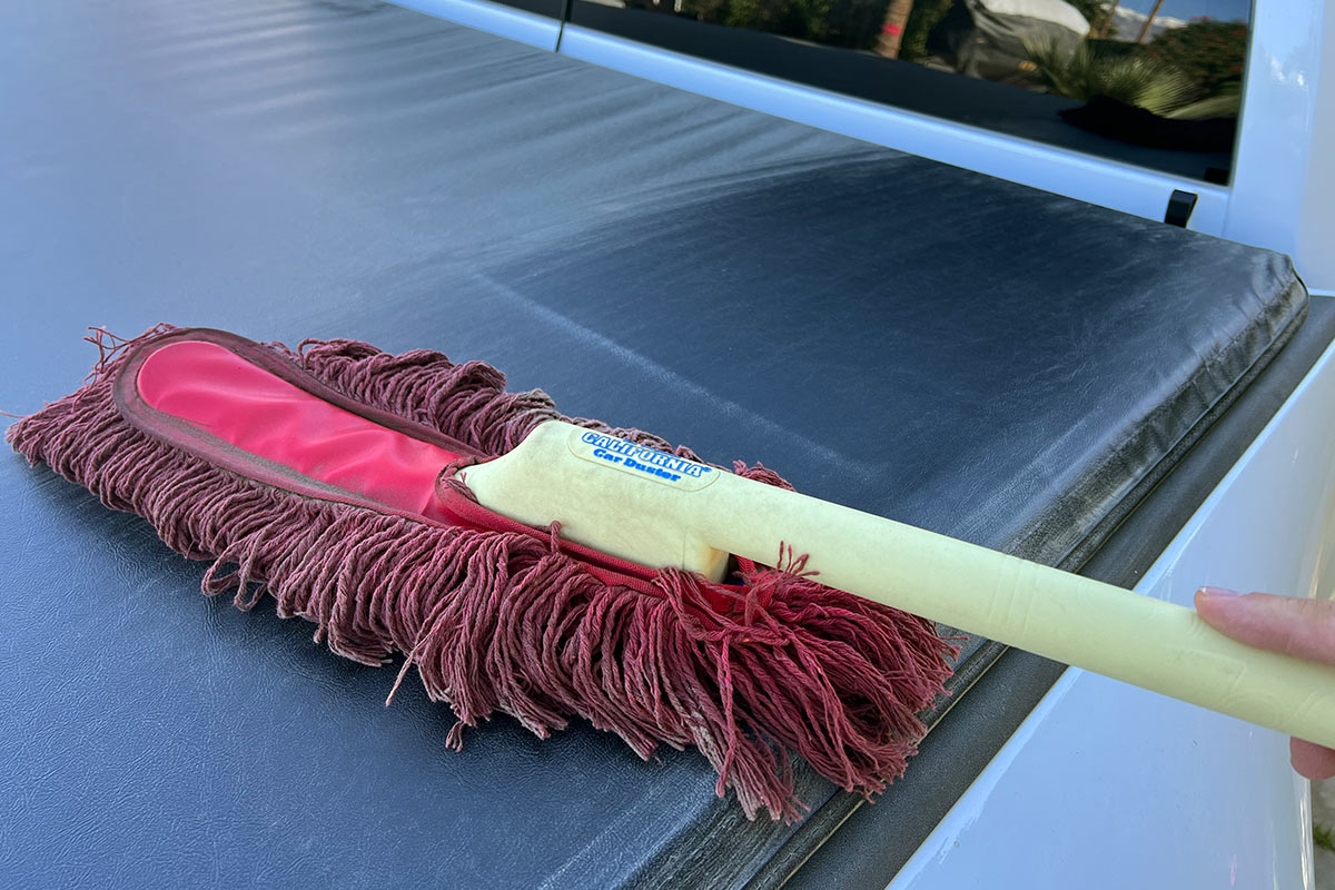 the Original California Car Duster is used to wipe down a truck bed cover