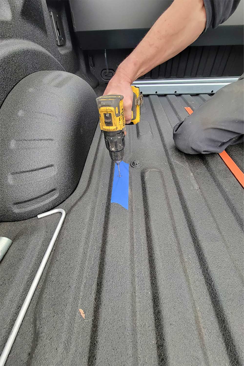 drilling pilot holes in the truck bed