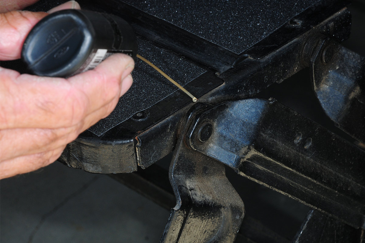 a small dot of lubricant is applied to an RV entry step hinge