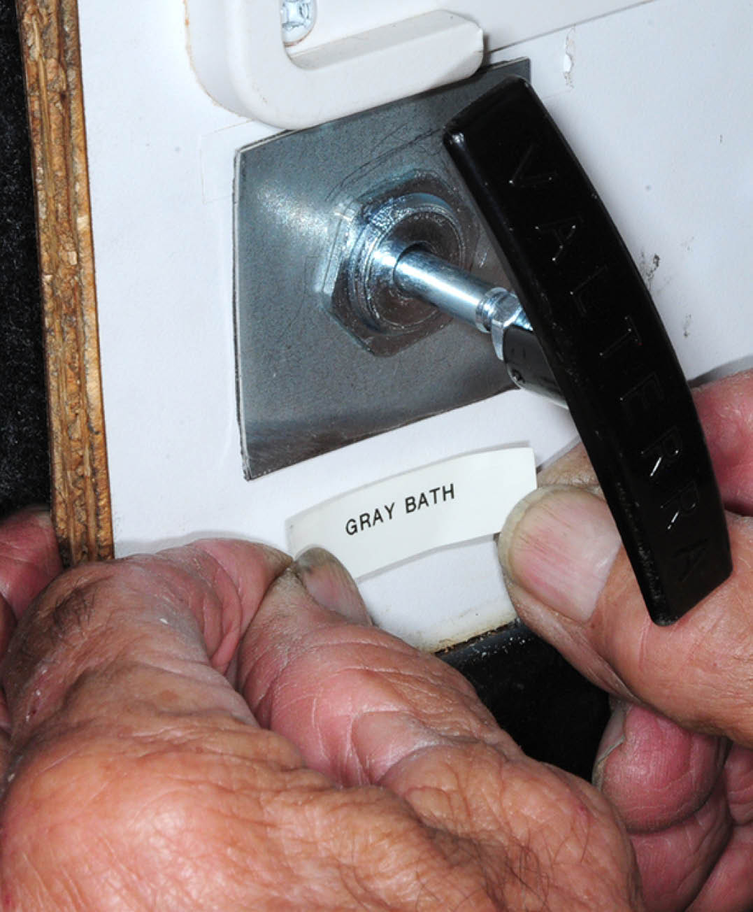 with the red tab removed a label is placed to identify the corresponding holding tank