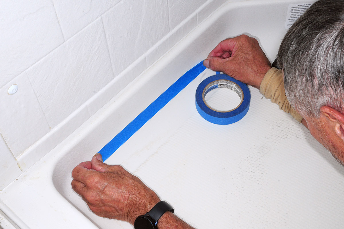 blue masking tape is used to block areas in the shower pan