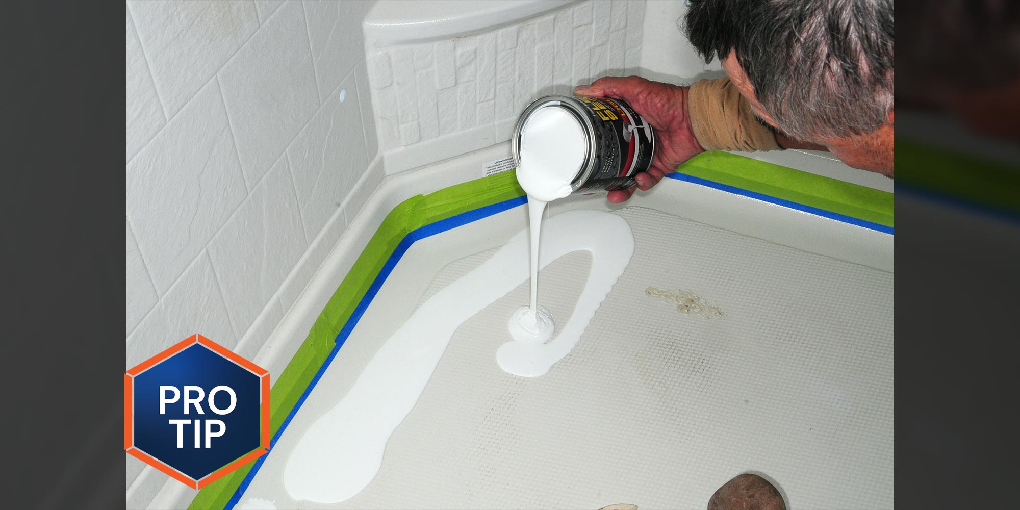 a man pours white liquid flex seal onto the floor of an RV shower pan