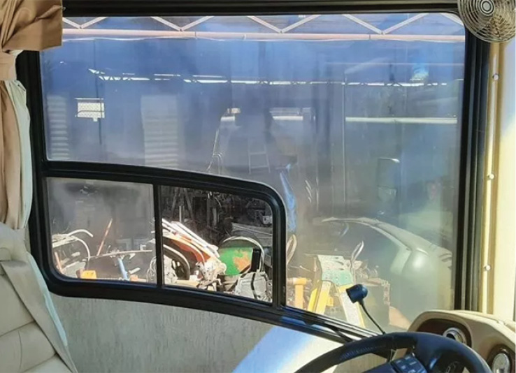 a foggy dual pane window at the drivers seat of an RV
