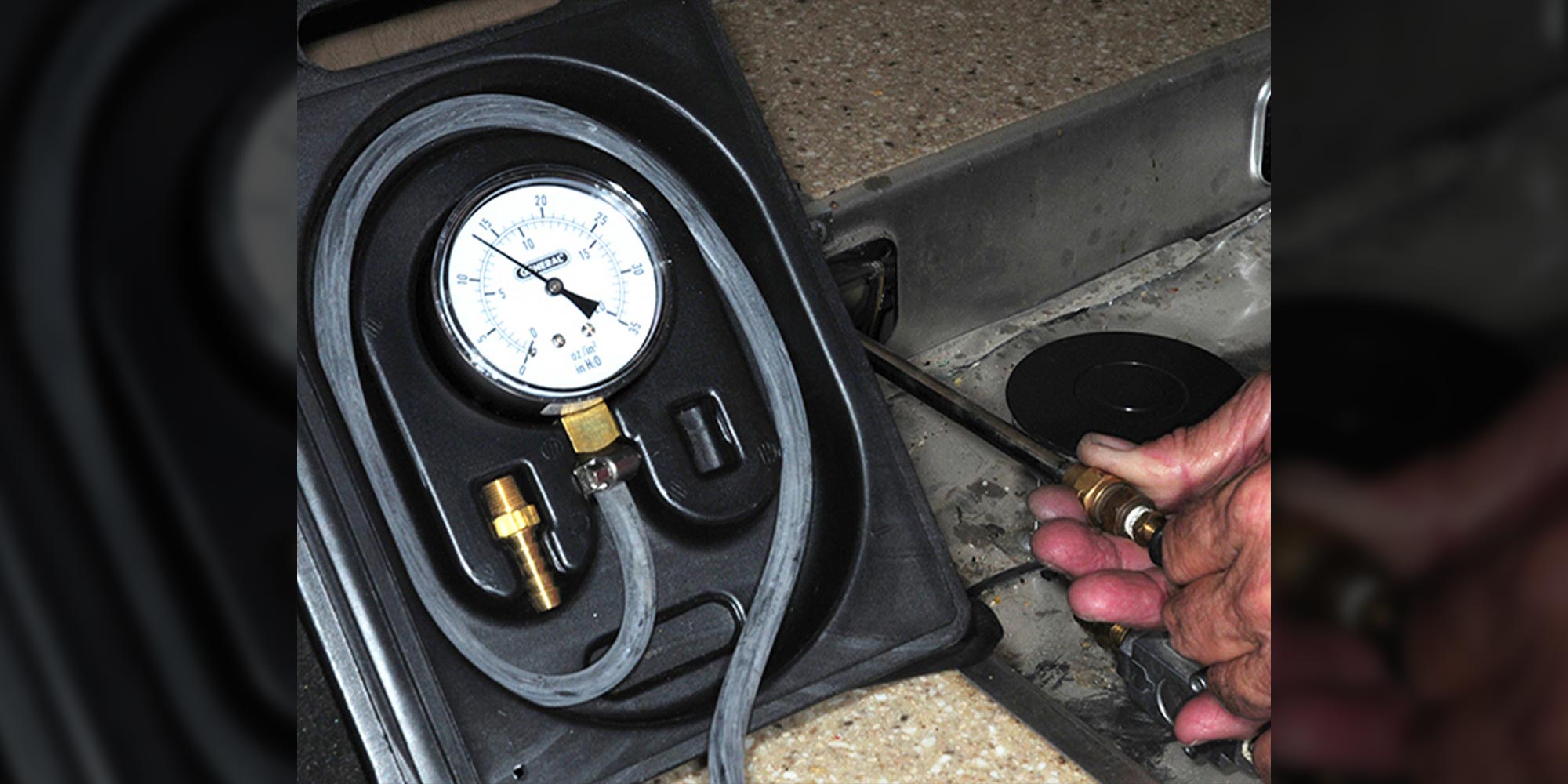 a device being used to measure LP gas pressure in a RV