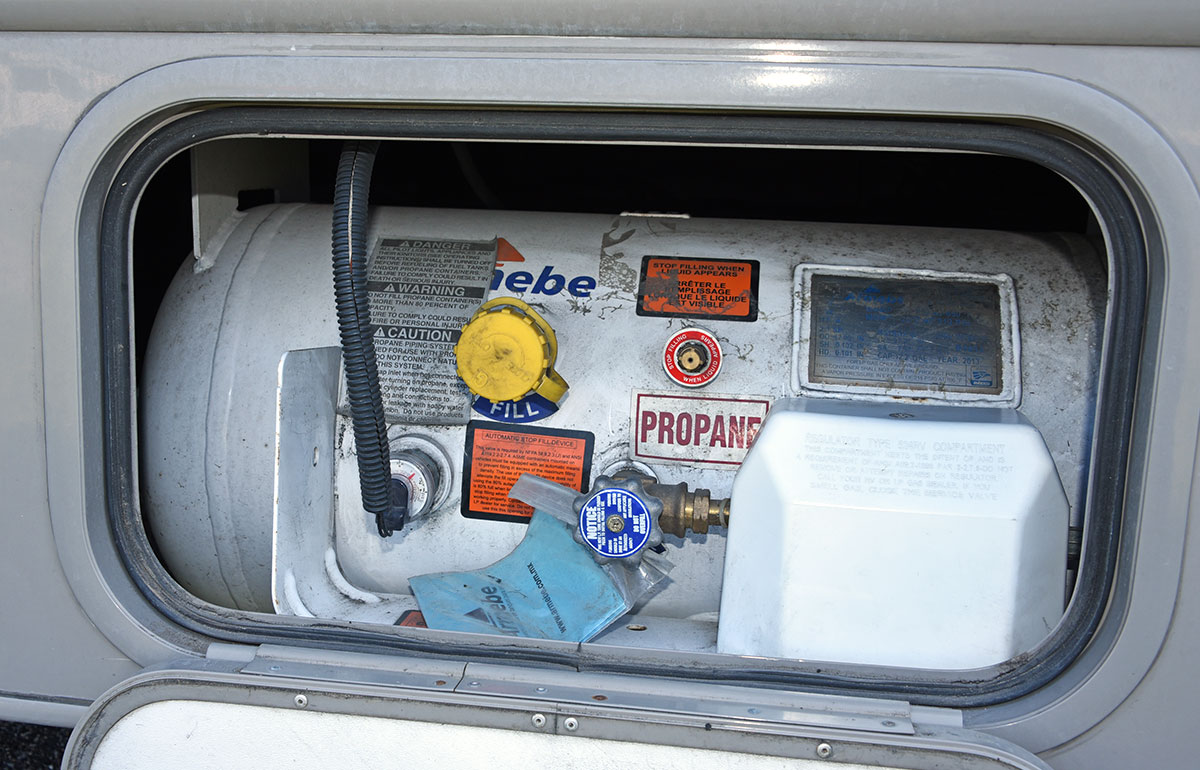 a propane tank in an external RV compartment