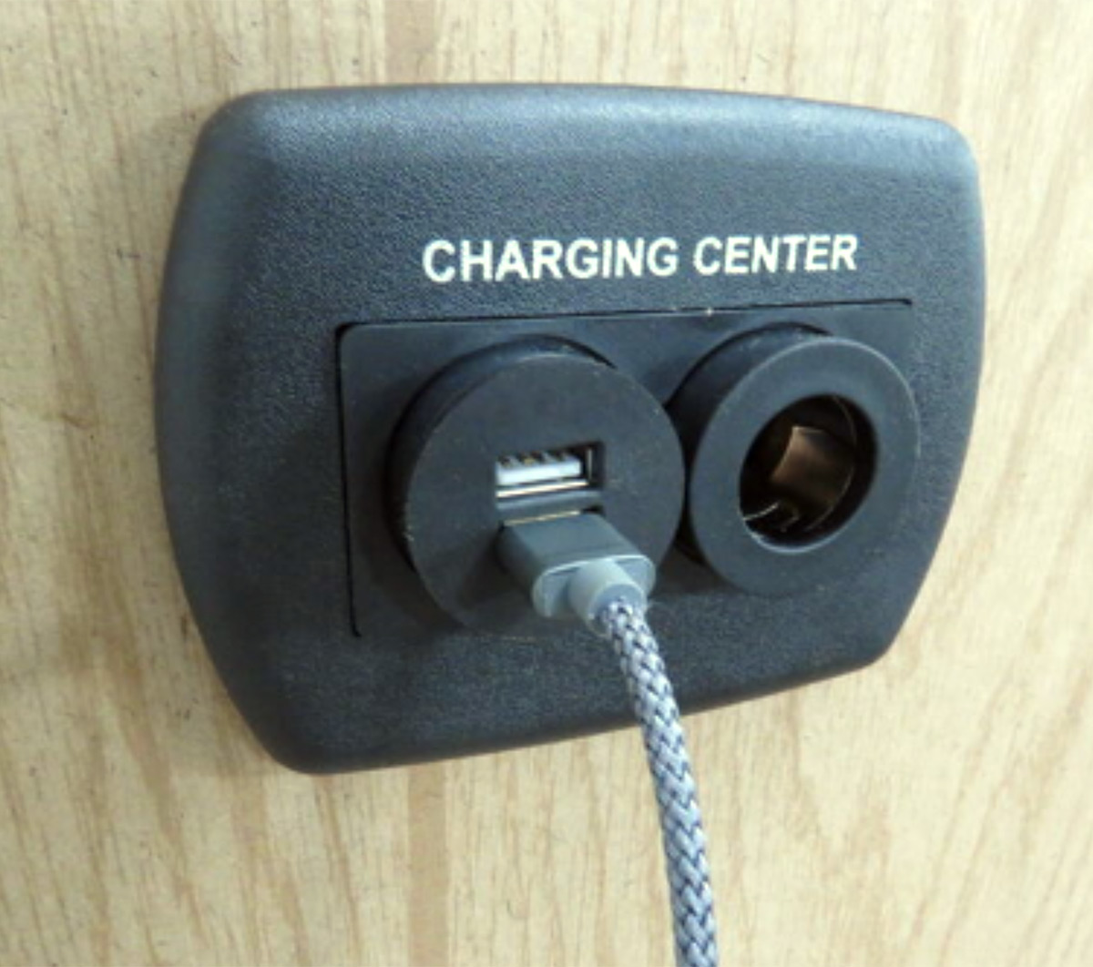 close view of a USB and 12V-10A compatible charging center on a wall