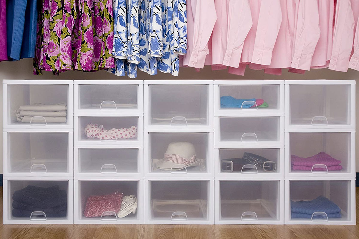 a line of Sterilite drawers of differing sizes are stacked at the base of closet