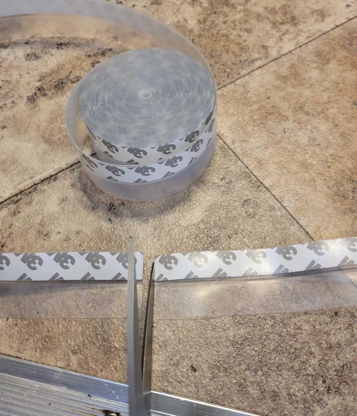a roll of 3M’s silicone seal strip beside a recently cut strip of seal