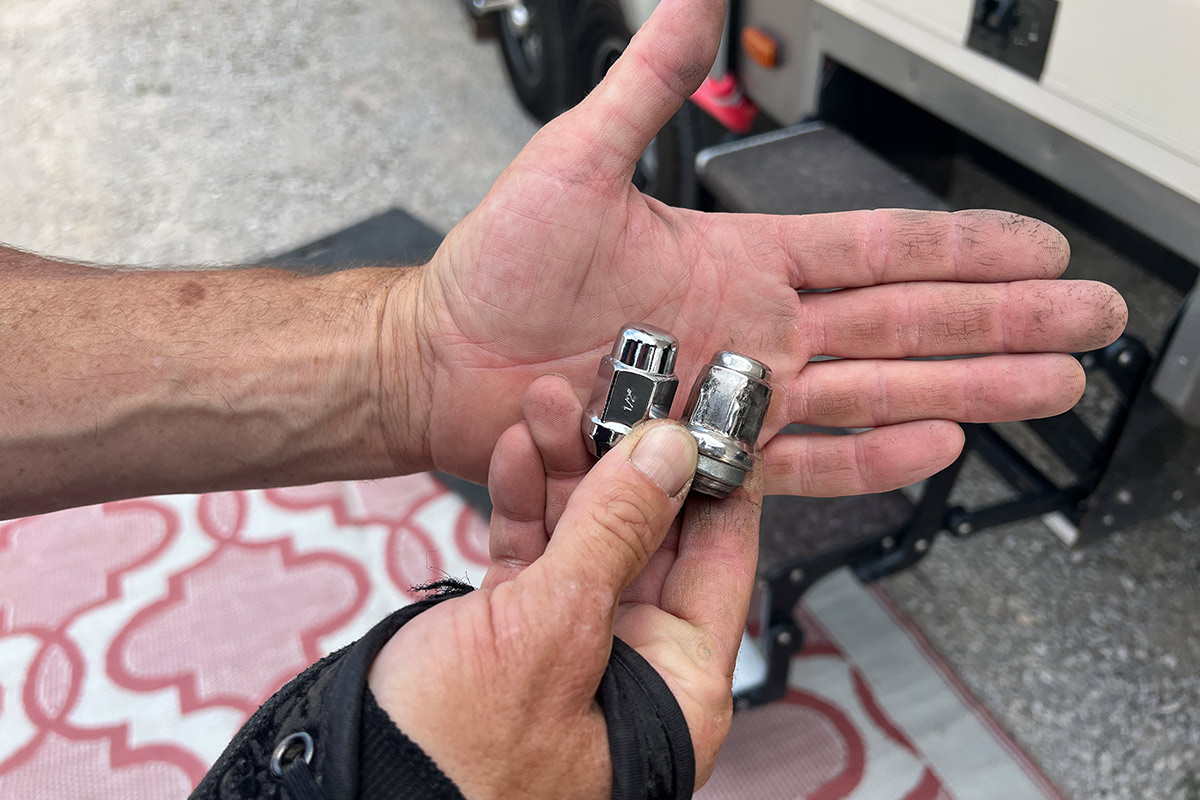 the original lug nut (right) is held beside the new lug nut (left) for comparison