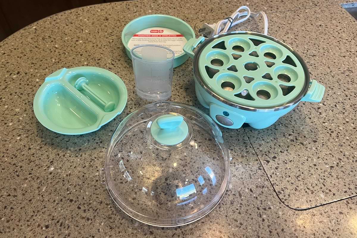 the parts of the Dash Rapid Egg Cooker sit on a counter