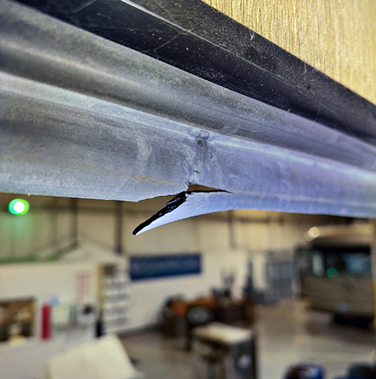 close view of a tear in the middle of the top wiper seal on a Monaco motorhome’s wall-slide