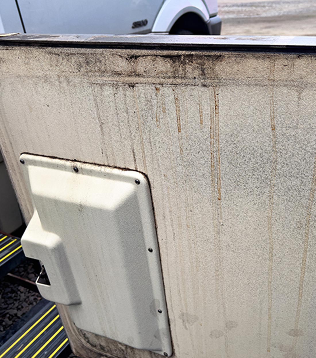 an RV cargo compartment door showing signs of leak damage