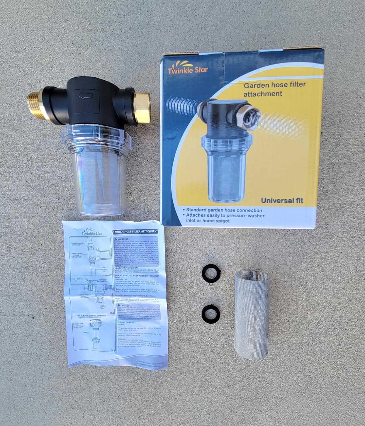 the Twinkle Star Garden Hose Filter Attachment removed from and placed next to its box packaging along with the accompanying mesh filter, and two hose O rings