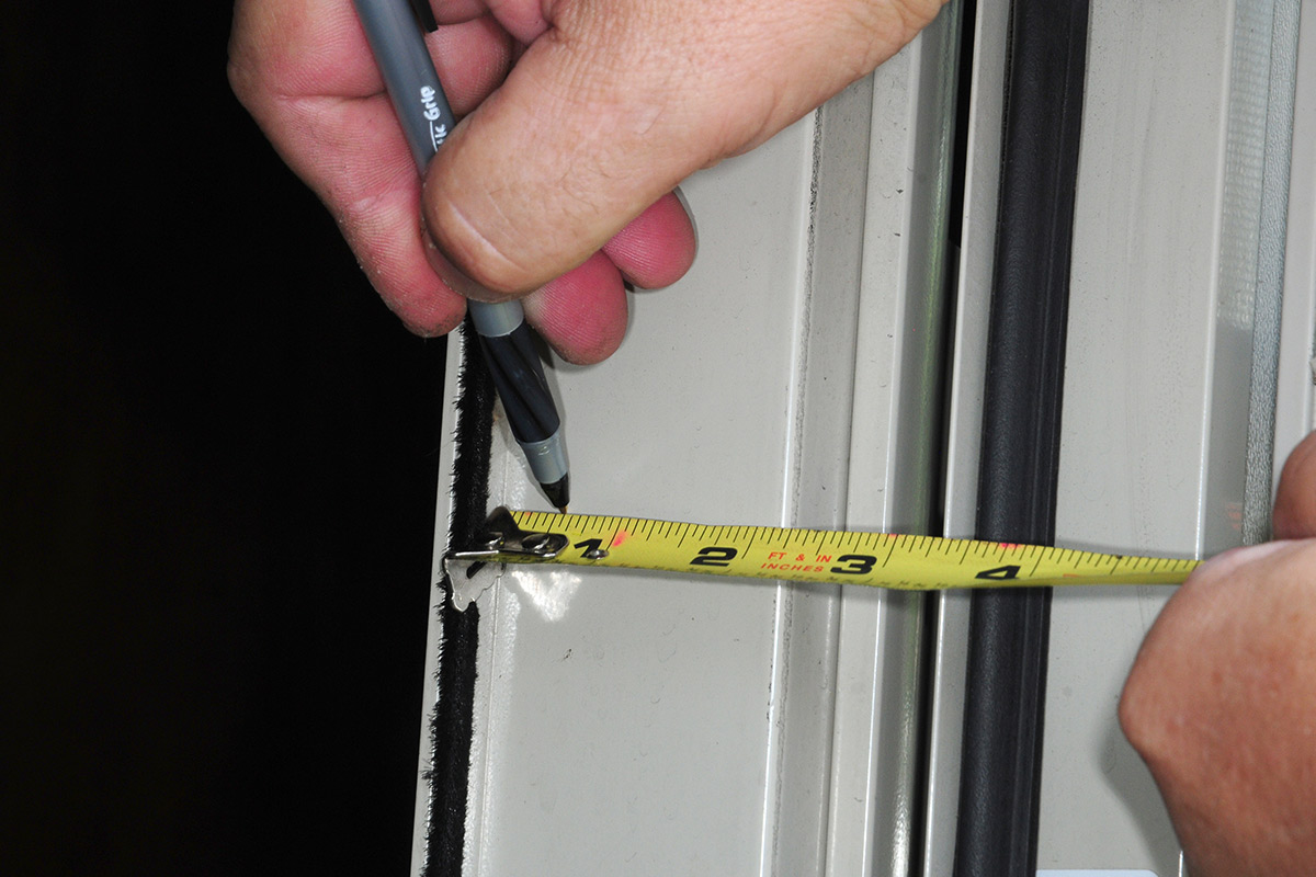 mounting location for the webbing on the door jamb is measured at ½-inch from the edge and marked with a pen